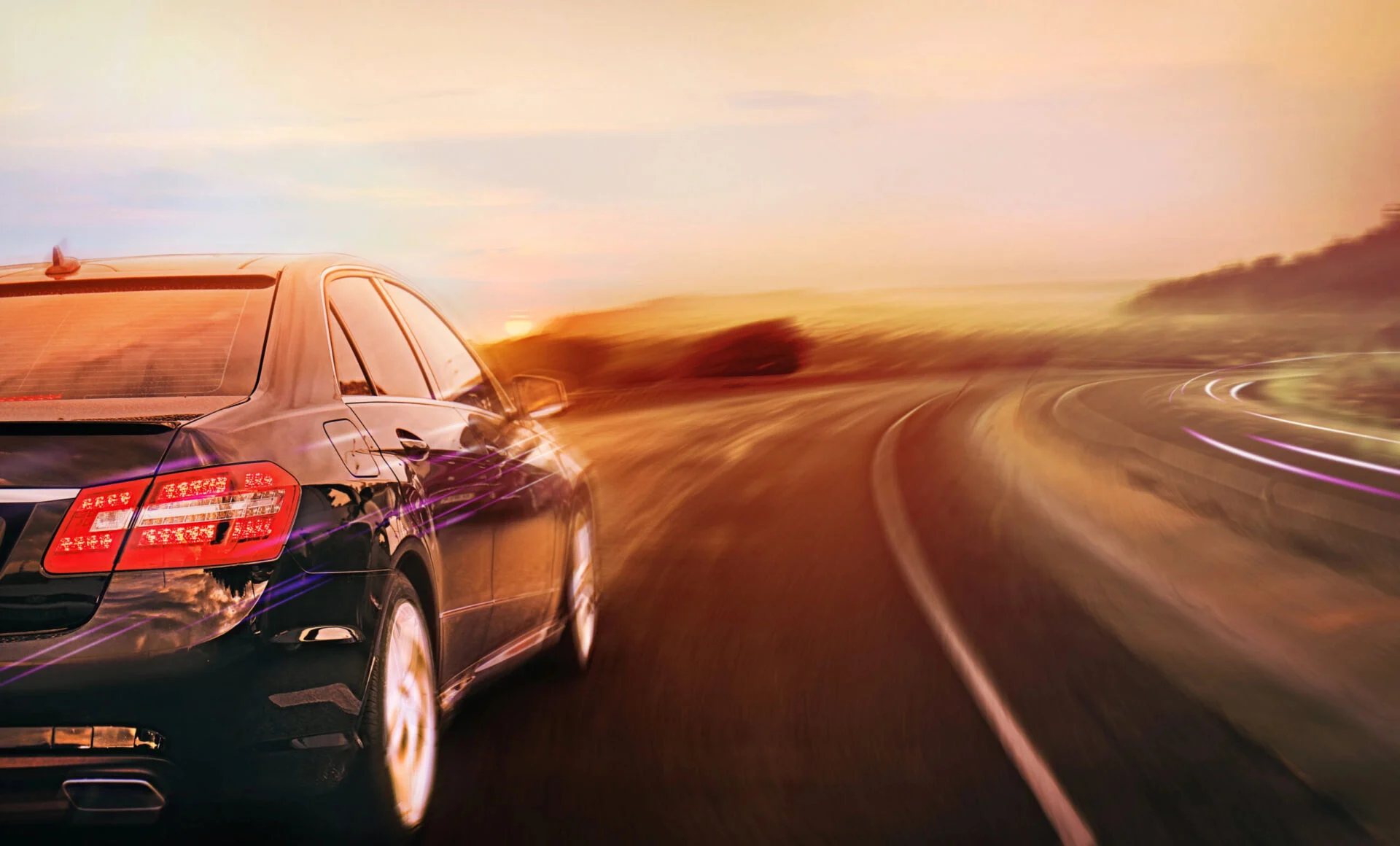 Blurry photo of a car driving along a road