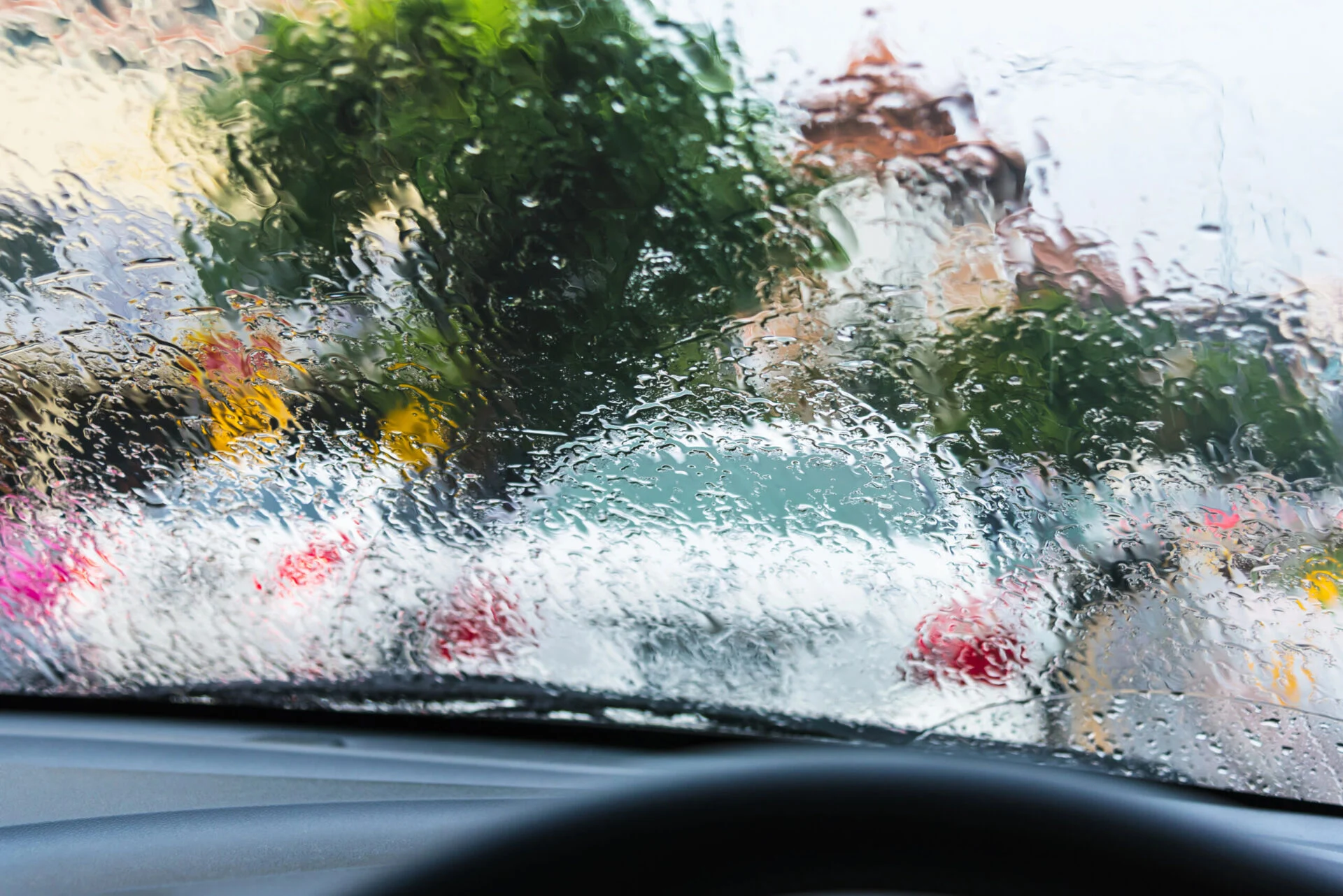 Car windshield with rain in the evening.