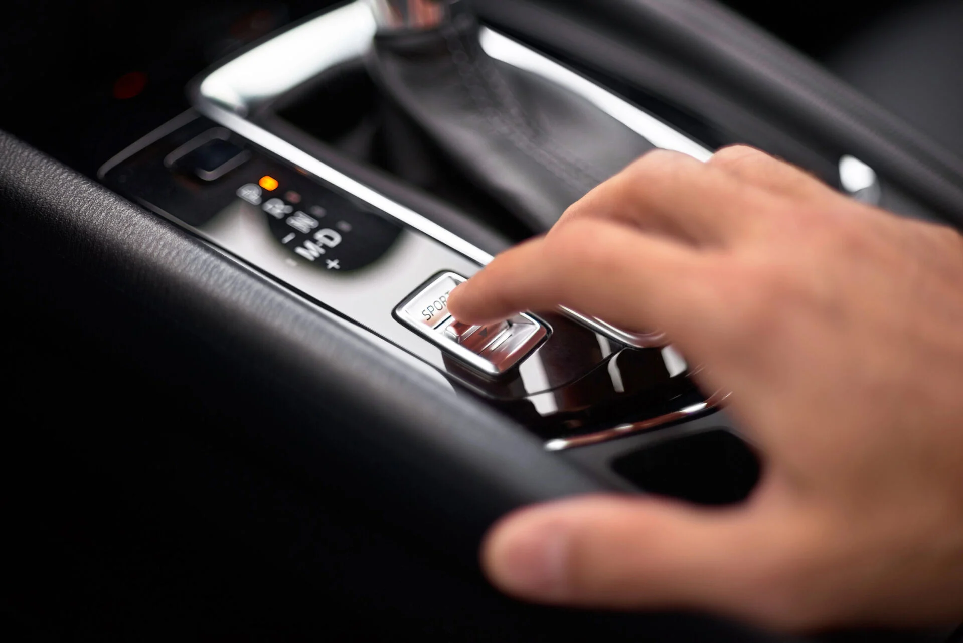Close up of hand changing to Sport Mode in car