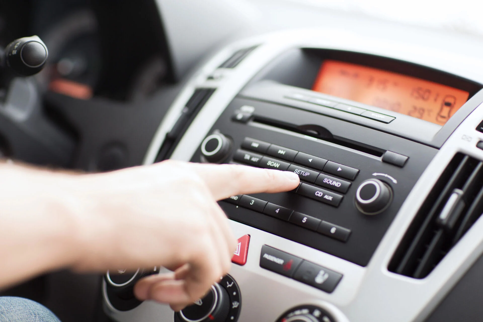 Person changing the settings in their car by using the centrol control panel