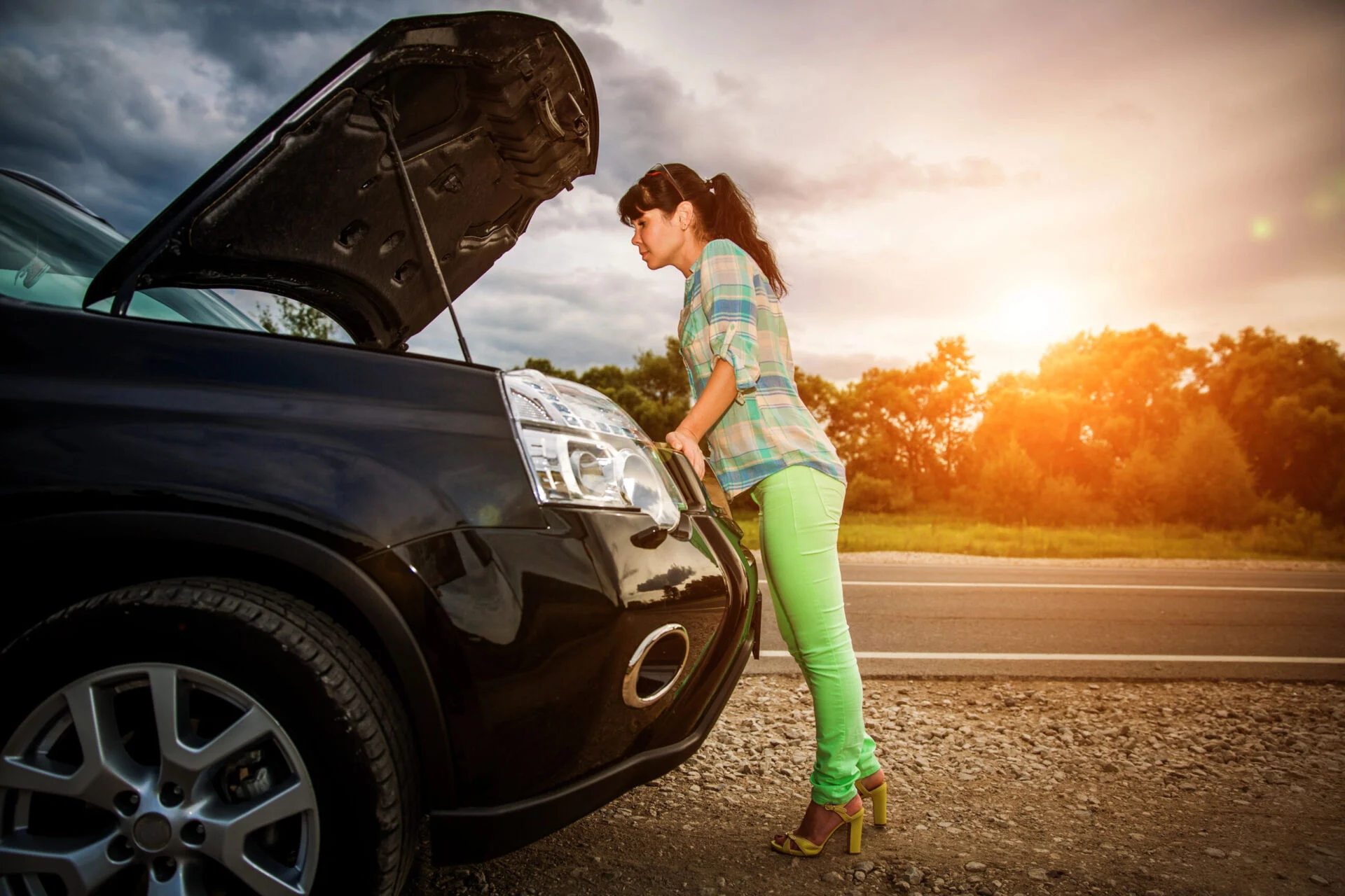Women looking into car hood